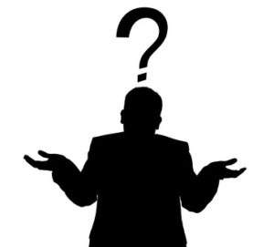 Silhouette of a man in a business suit giving a shrug with a question mark