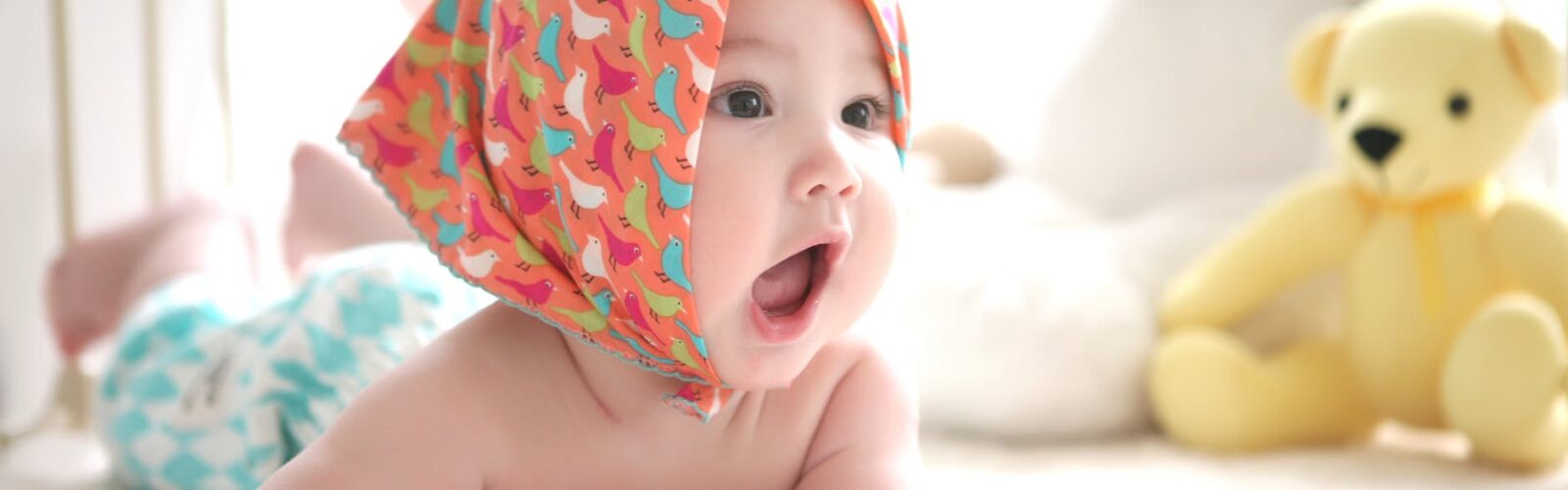 toddler wearing head scarf in bed