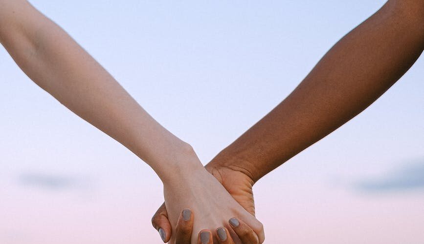 photo of people holding hands