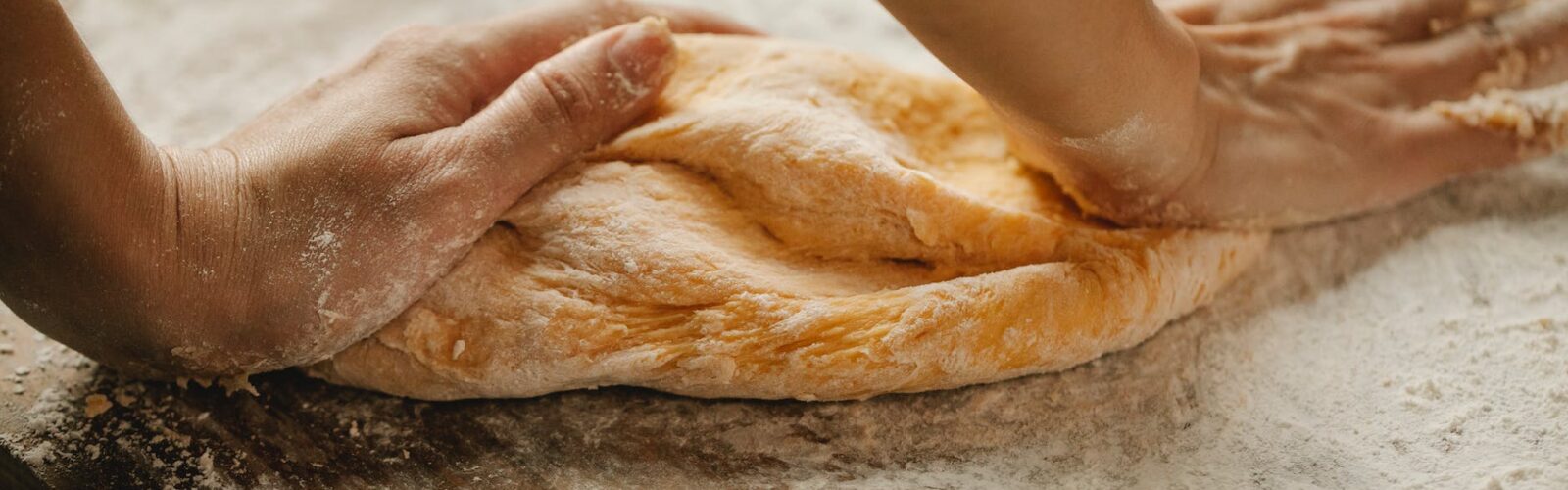 chef making fresh pastry on table in bakery