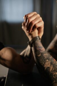 close up view of people doing an arm wrestling match