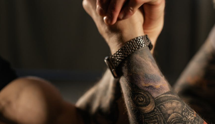 close up view of people doing an arm wrestling match