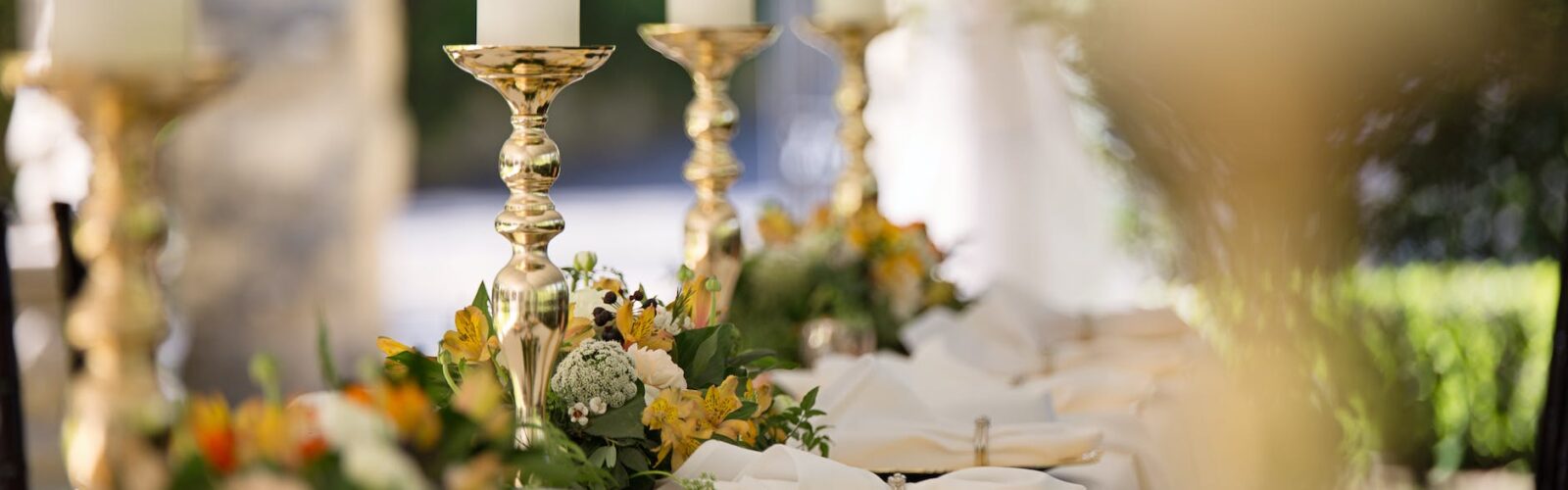 selective focus of candlesticks on table with wedding set up